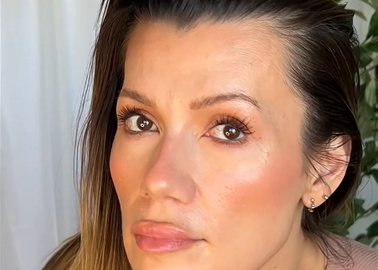 Close-up of a person with makeup on a neutral background