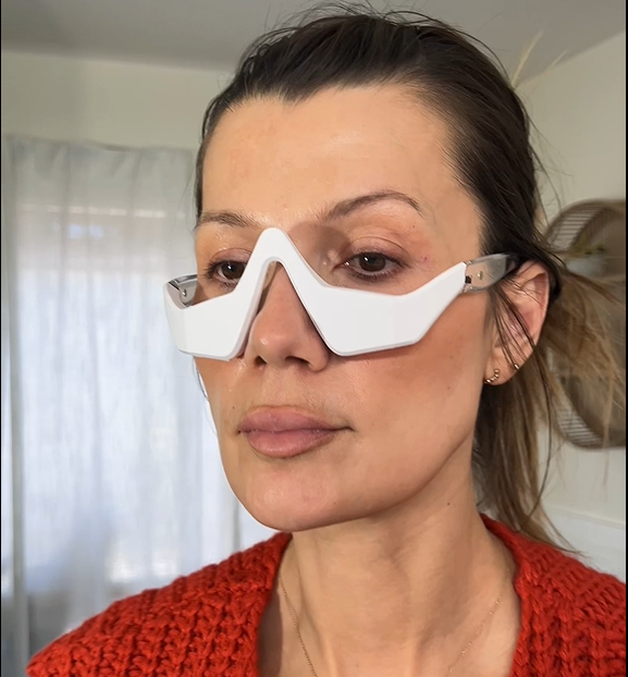 Person wearing a pair of white goggles with a blurred background