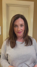 Woman smiling after using red light therapy device