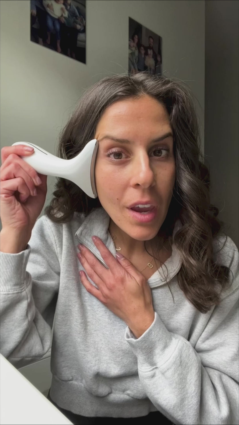 Woman demonstrating how to use LED light therapy device