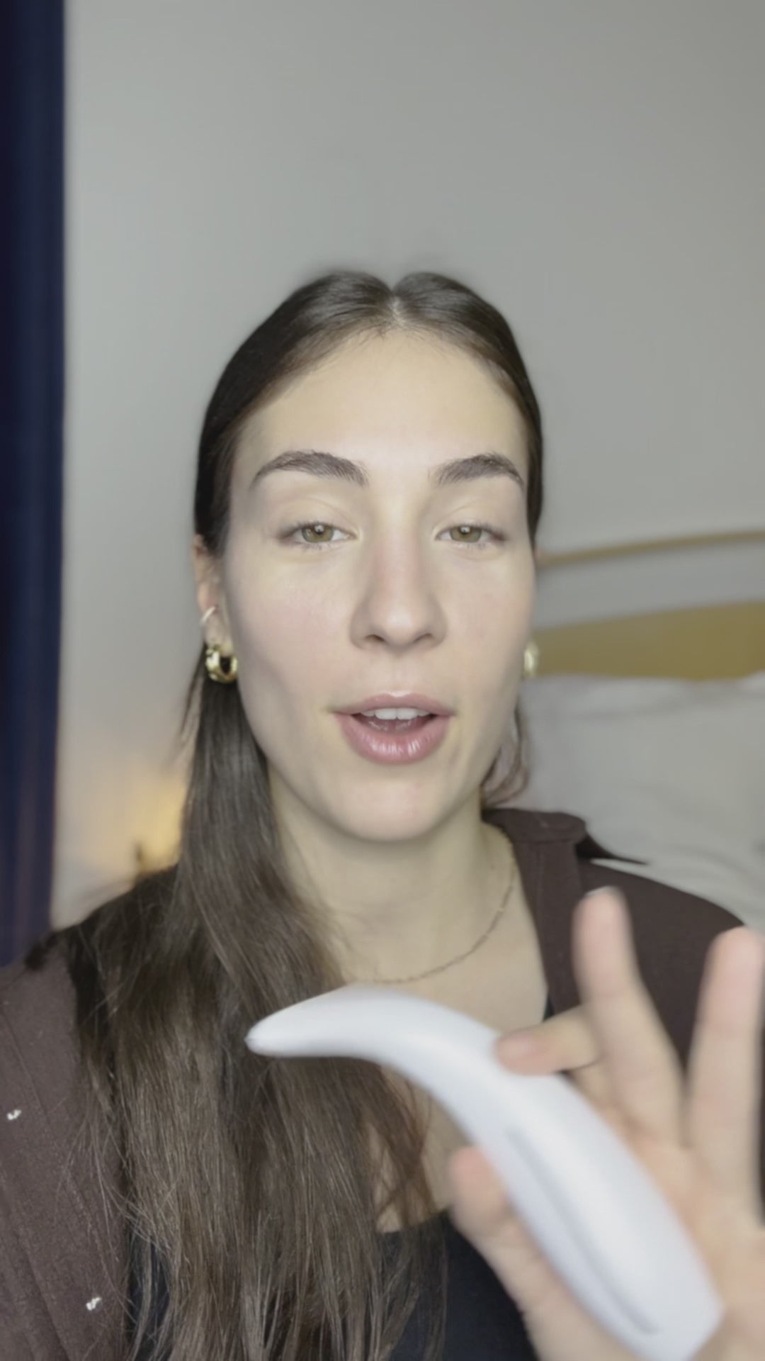 Woman using LED light therapy facial device