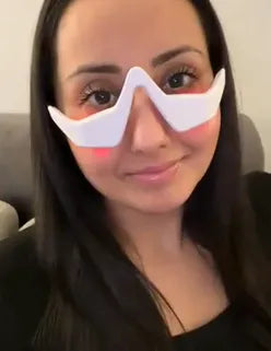 Person wearing a RevitalEyes Red Light over their eyes with a plain background